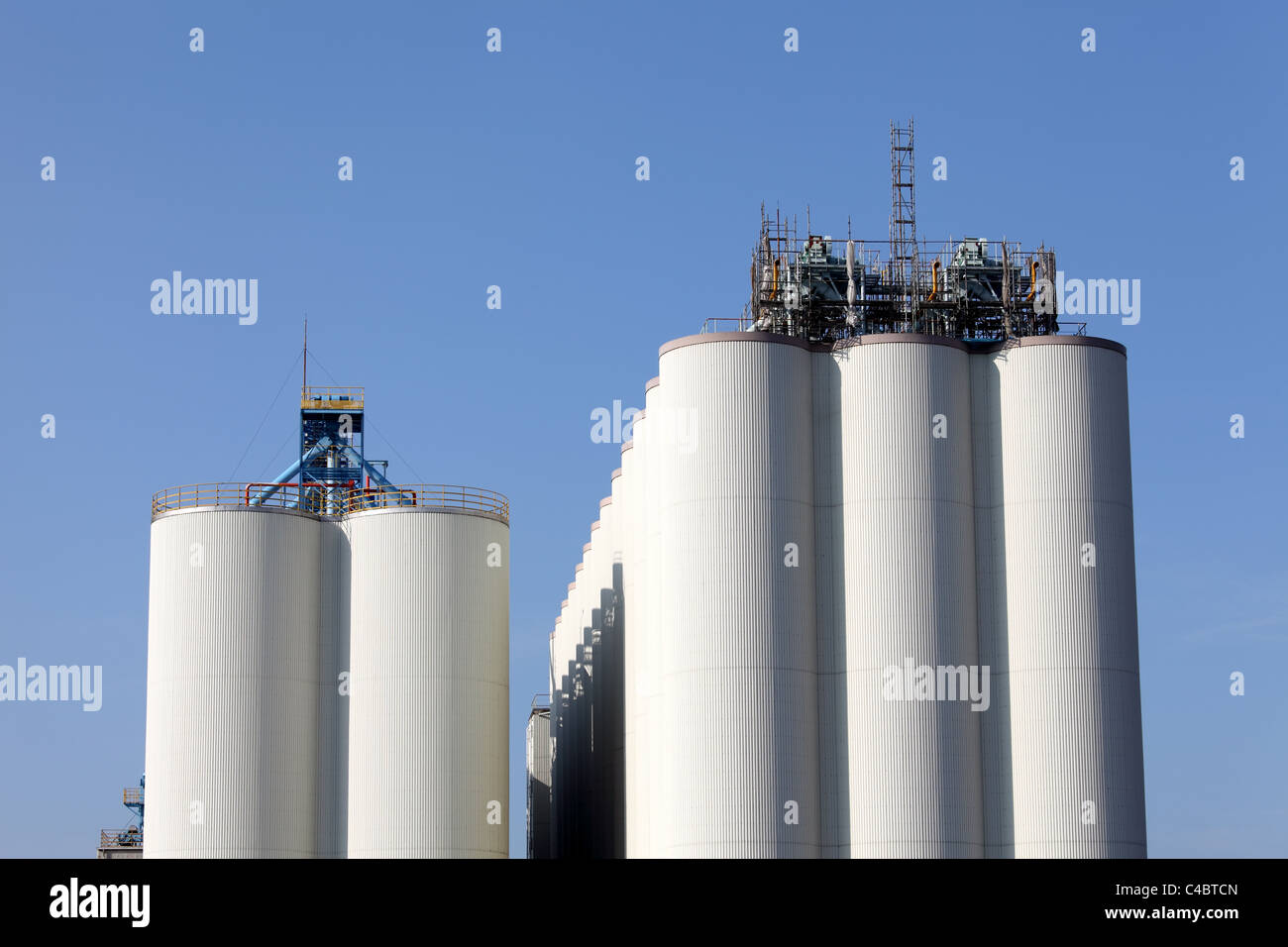 Industrial silo against the blue sky Stock Photo - Alamy