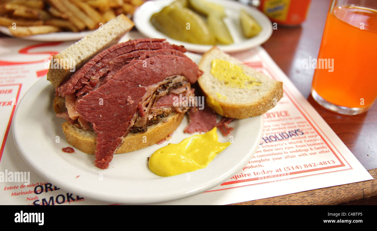 A smoked meat sandwich and pickles at Schwartz's in Montreal, a Hebrew Delicatessan that opened in 1928 Stock Photo