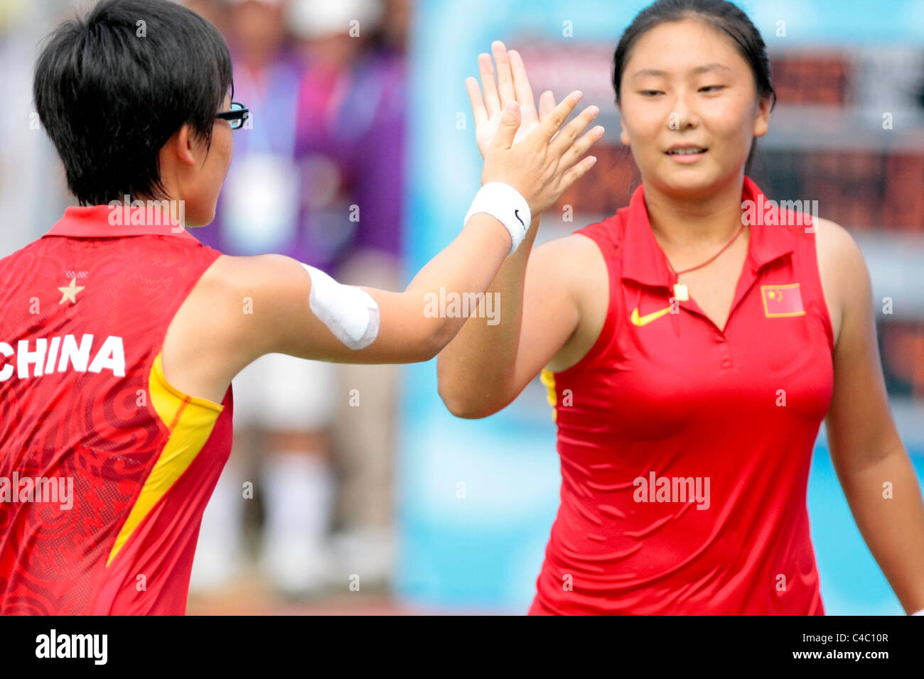 Team China's Zheng Saisai(left) and Tang Hao Chen(right) react after