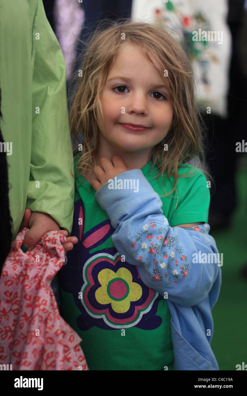 little girl holding her mother's hand at the Hay Literary Festival, 30 May 2011 Stock Photo