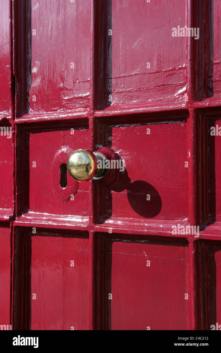 Brass door knob on heavily painted old wooden front door at Leaden Hall School The Close, Salisbury. Stock Photo