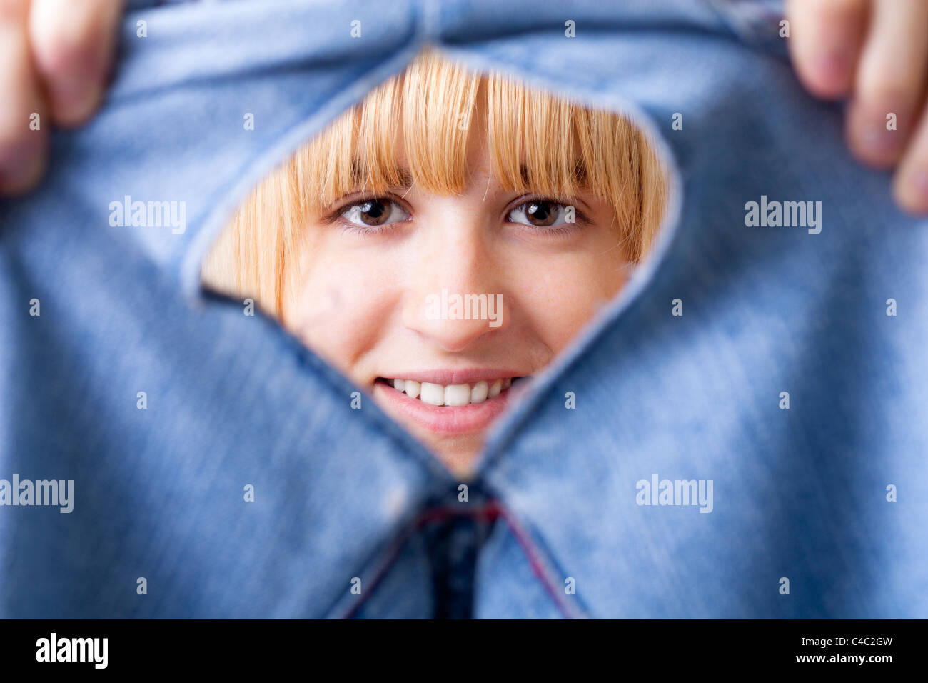 Smiling Woman with Torn Jeans Stock Photo