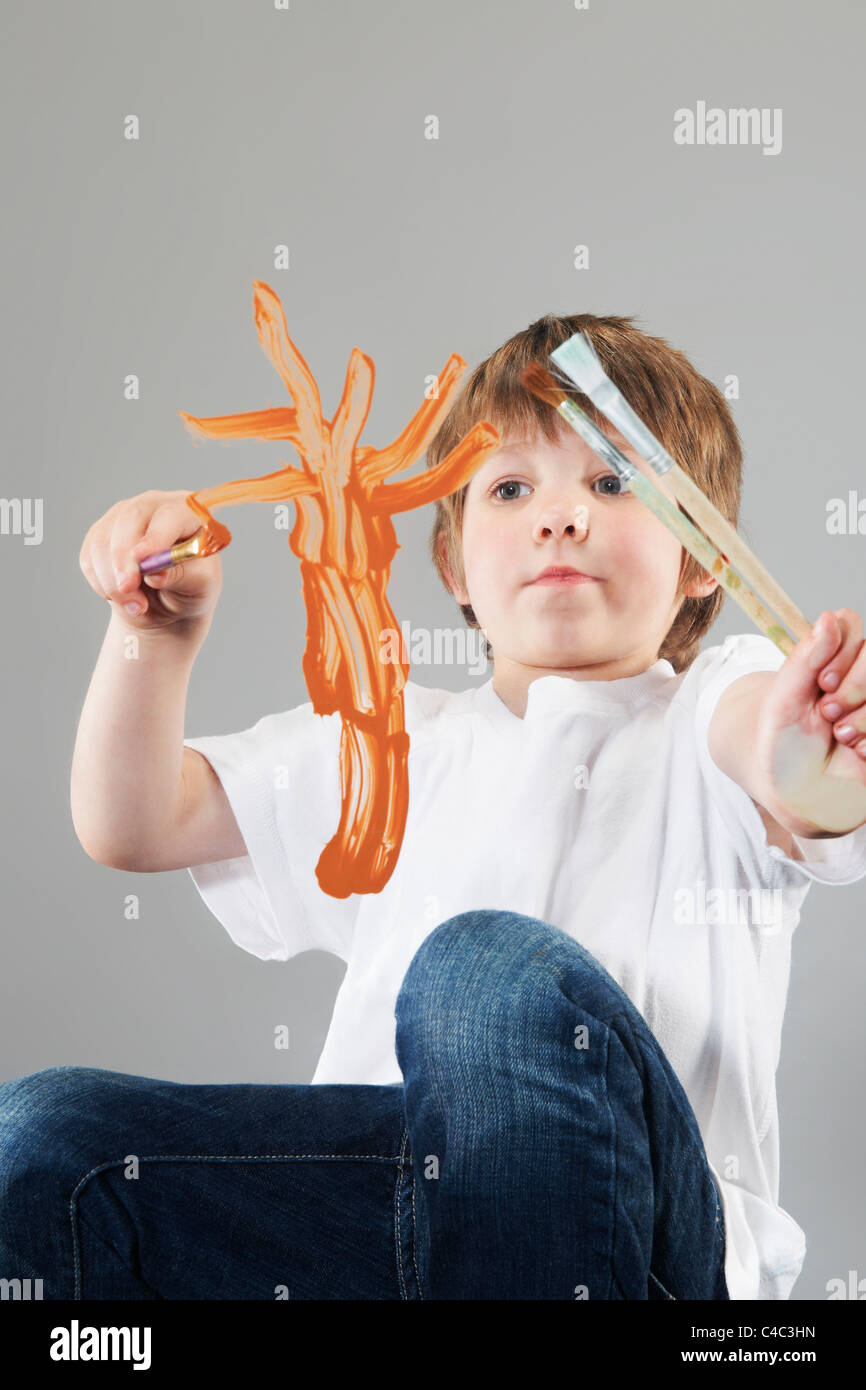 Boy painting on glass Stock Photo