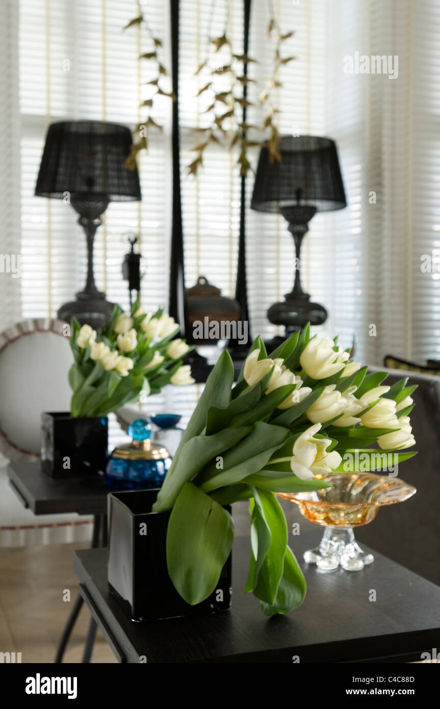 Bunch Of Tulips In A Black Square Vase With Mirror Reflection