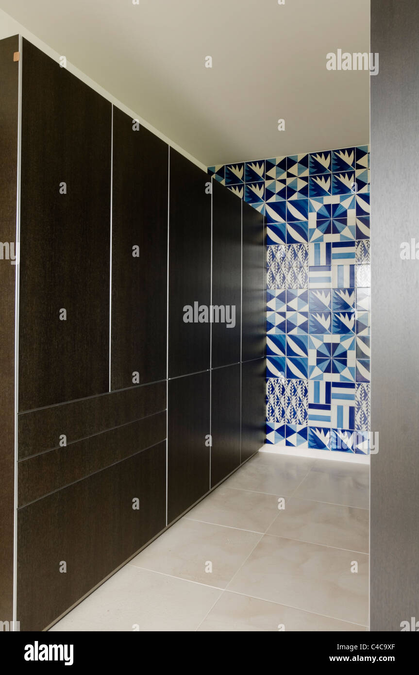 modern storage cupboards and blue and white tiling in the utility area of a contemporary villa in Spain, designed by Matteo Thun Stock Photo