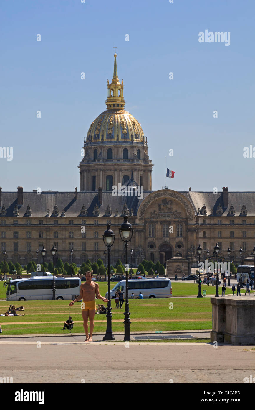 Parisian man exercises in the park with Les Invalides in the background Stock Photo
