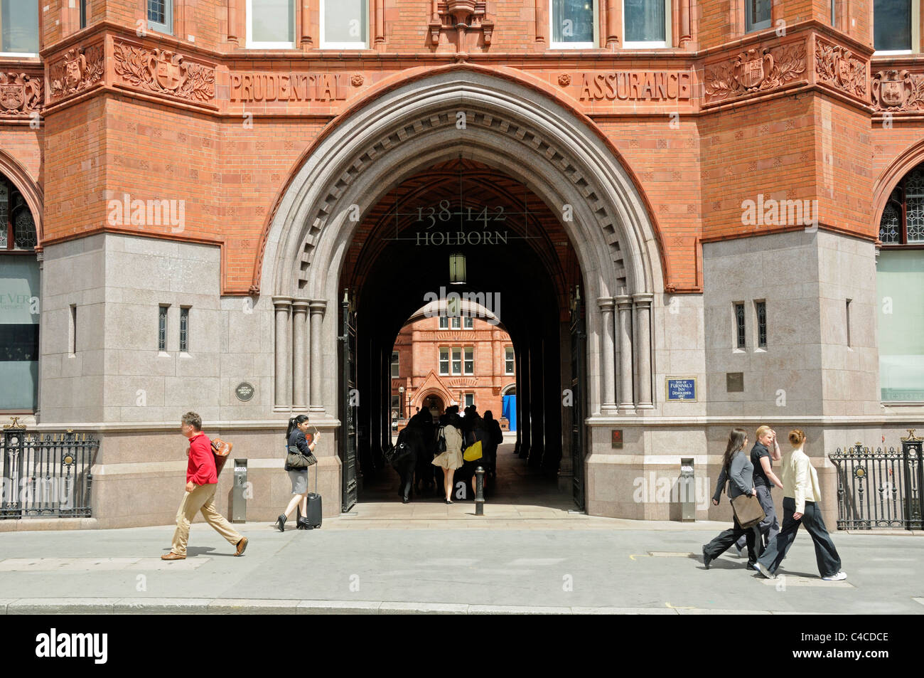 People passing the entrance to The old Prudential Assurance Building in High Holborn London England UK Stock Photo