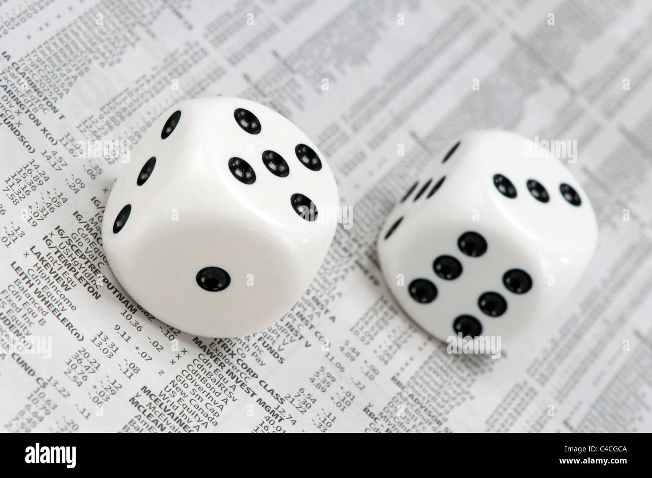 Dice on print out of market listings Stock Photo Alamy