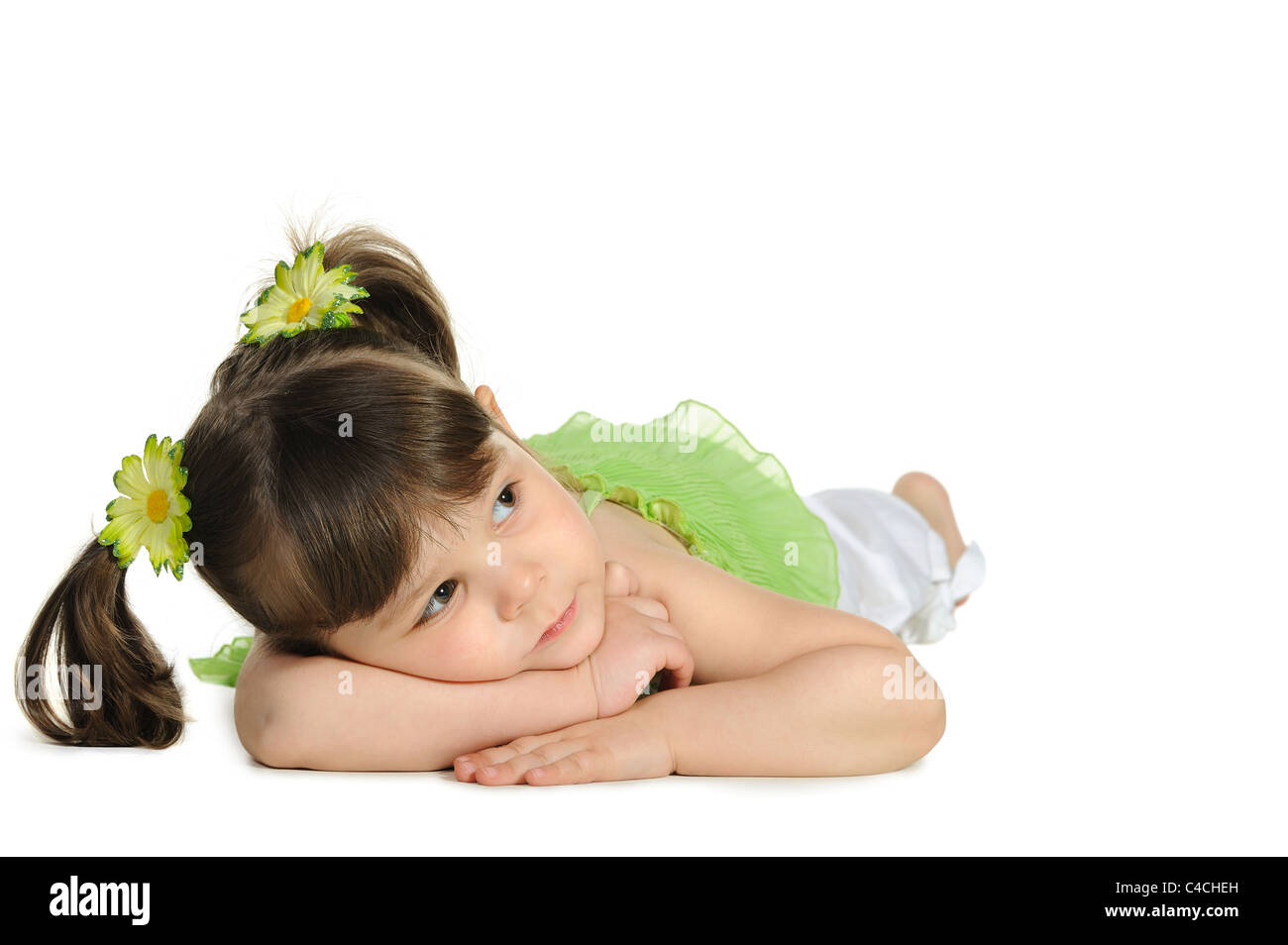 Pretty the little girl lies on the white. It is isolated on a white ...