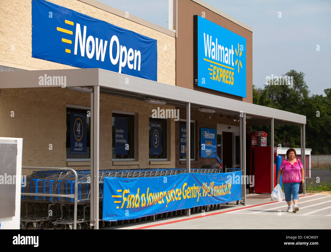 A woman exits a Walmart Express store in Gentry, Arkansas, U.S.A Stock