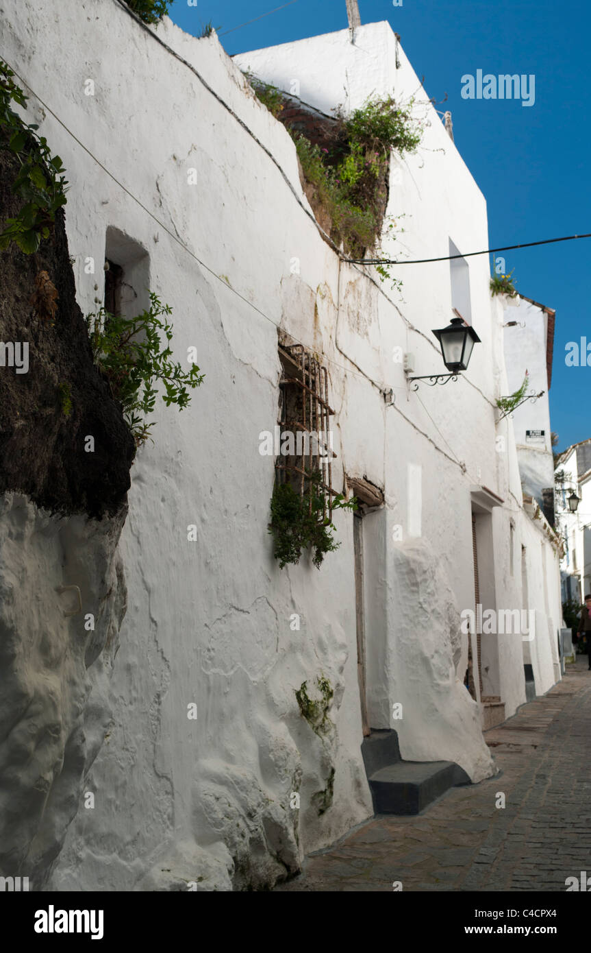 A typical Andalucian village street with an abandoned, decaying house next to a neat well kept one Stock Photo