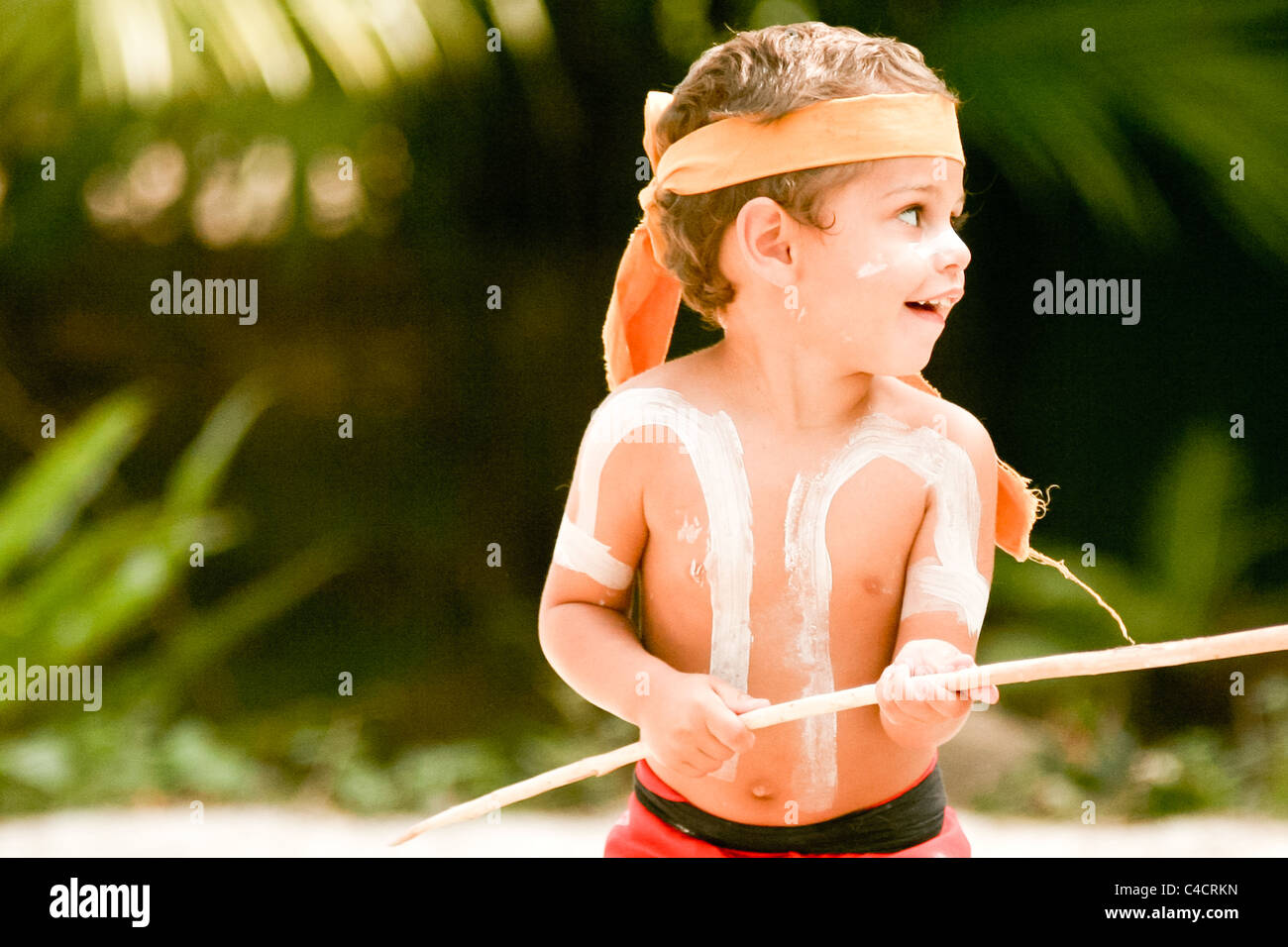 Young boy in aboriginal body paint dancing with a stick Stock Photo Alamy