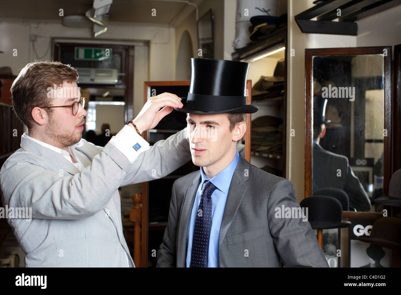 mn being fitted for a Silk Top Hat at Lock & Co hatters, St.James ...