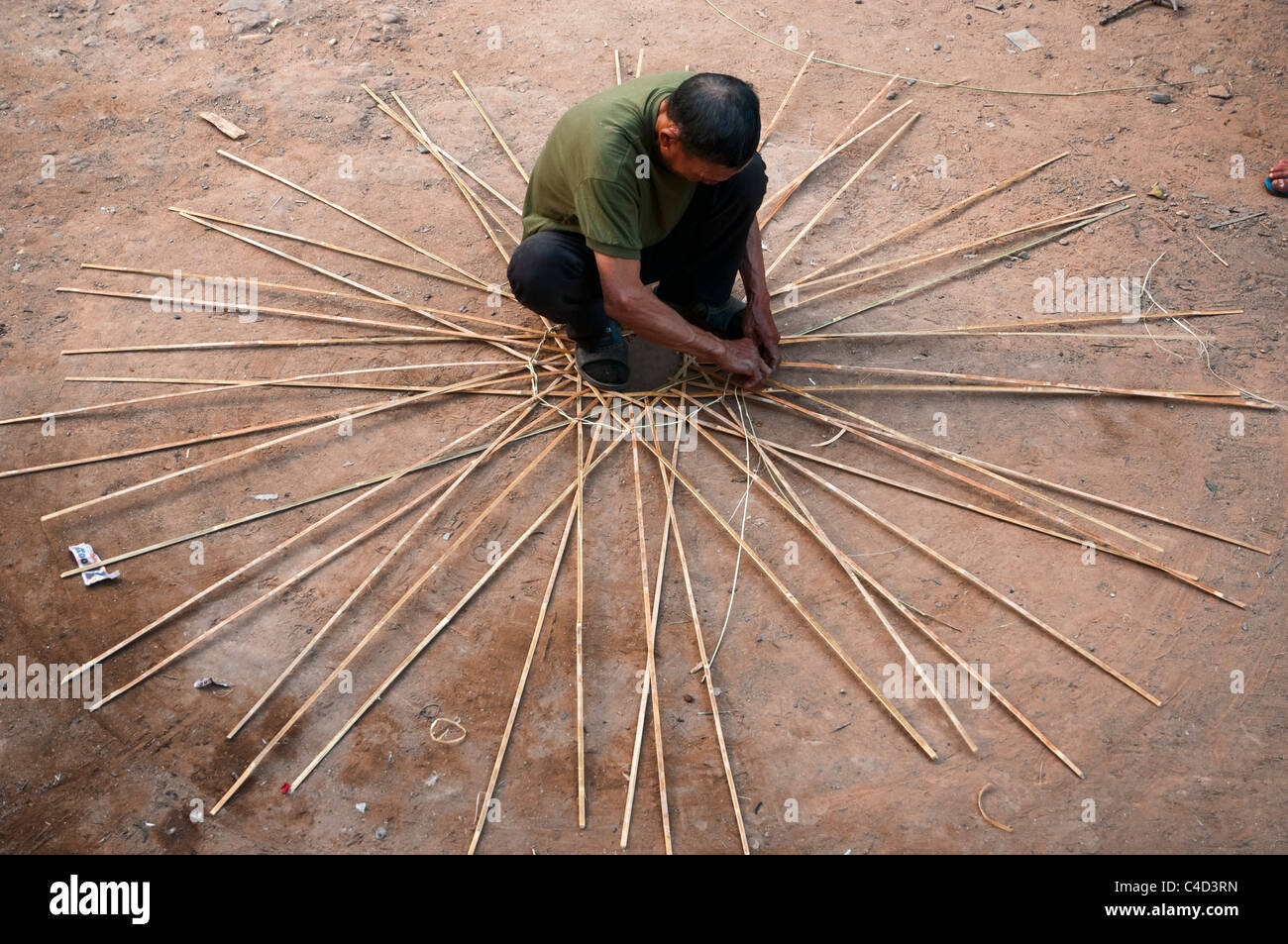 Laotian man waving a basket in Laos Stock Photo