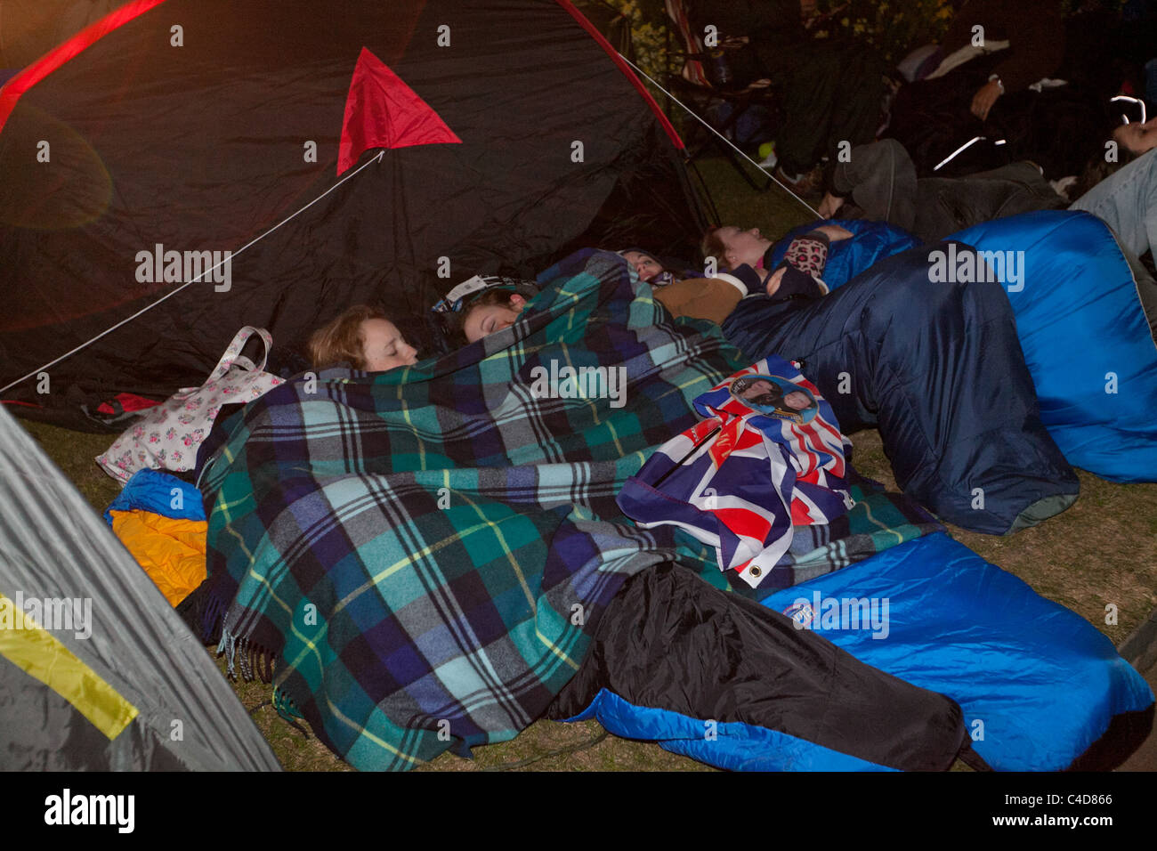 Festive crowds camping out in front of Buckingham Palace the night