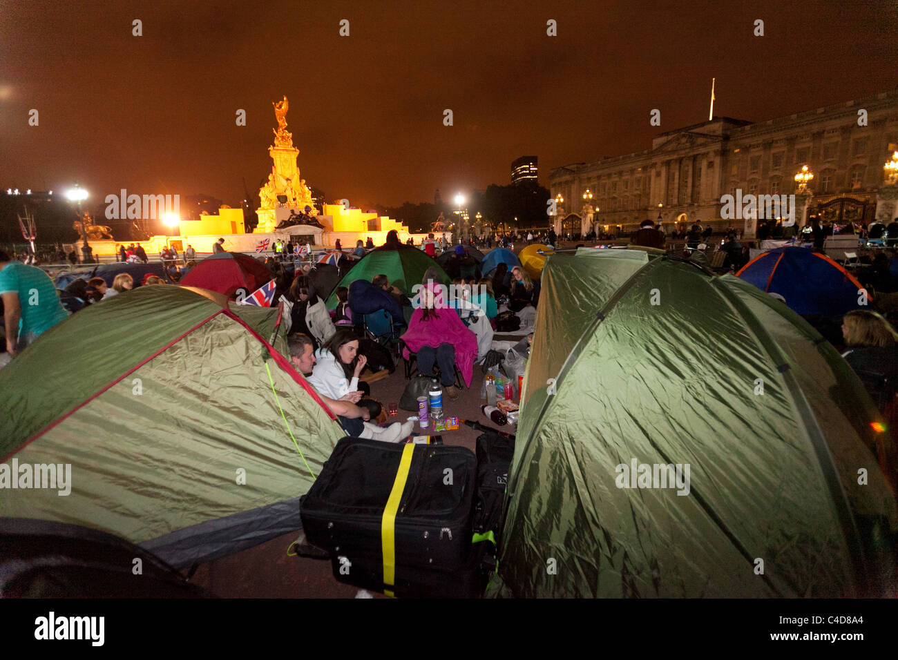 Festive crowds camping out in front of Buckingham Palace the night