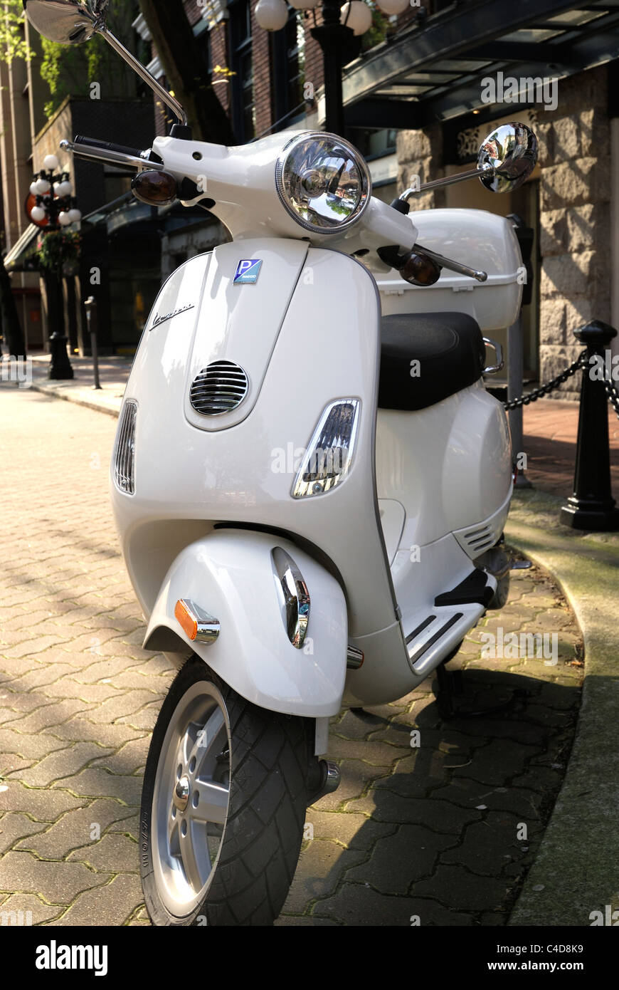 Front end of a white Vespa scooter parked on the street Stock Photo - Alamy