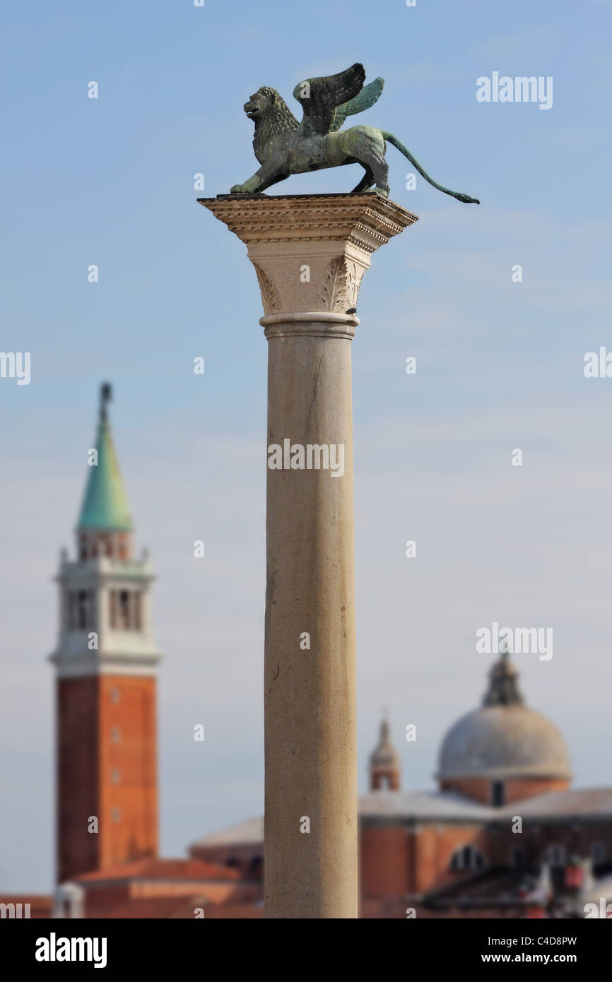 Column with lion-symbol of Venice in front of San Giorgio Maggiore church in Venice, Italy. Stock Photo