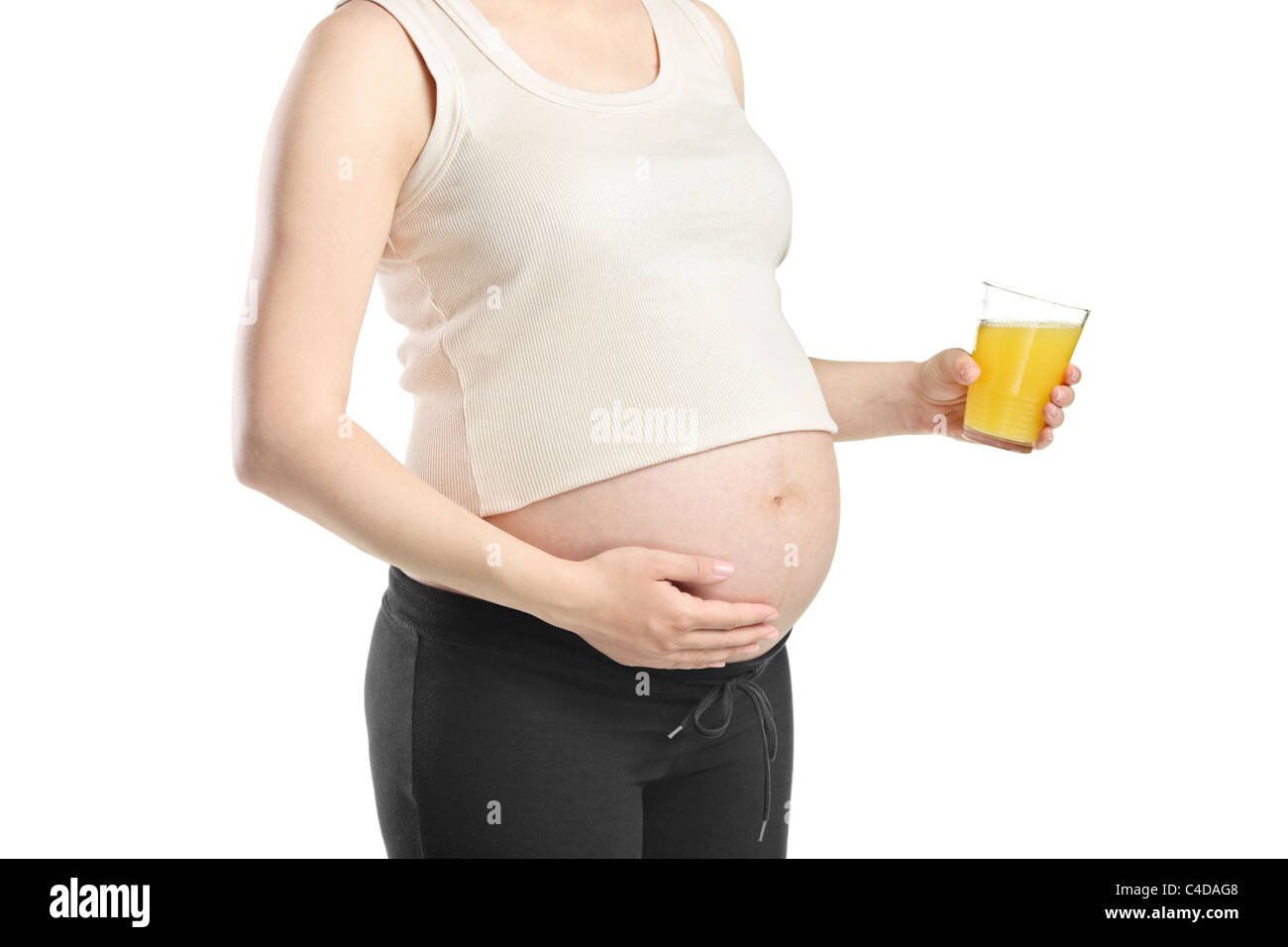 A view of a pregnant woman holding a glass of orange juice Stock Photo ...