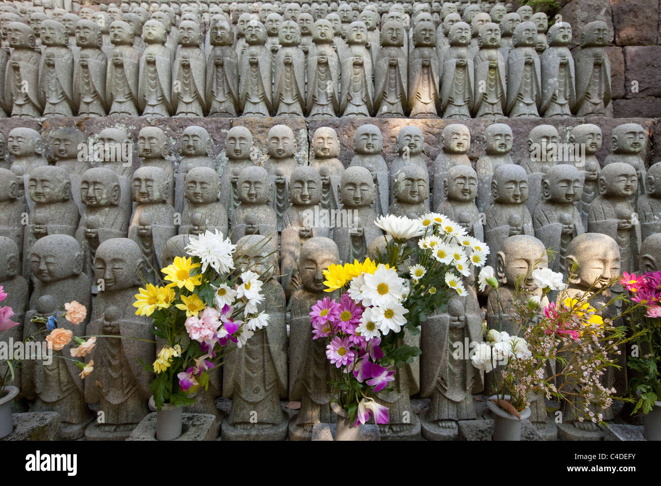 Jizo statues and flowers at Hasedera temple, Kamakura, Japan Stock