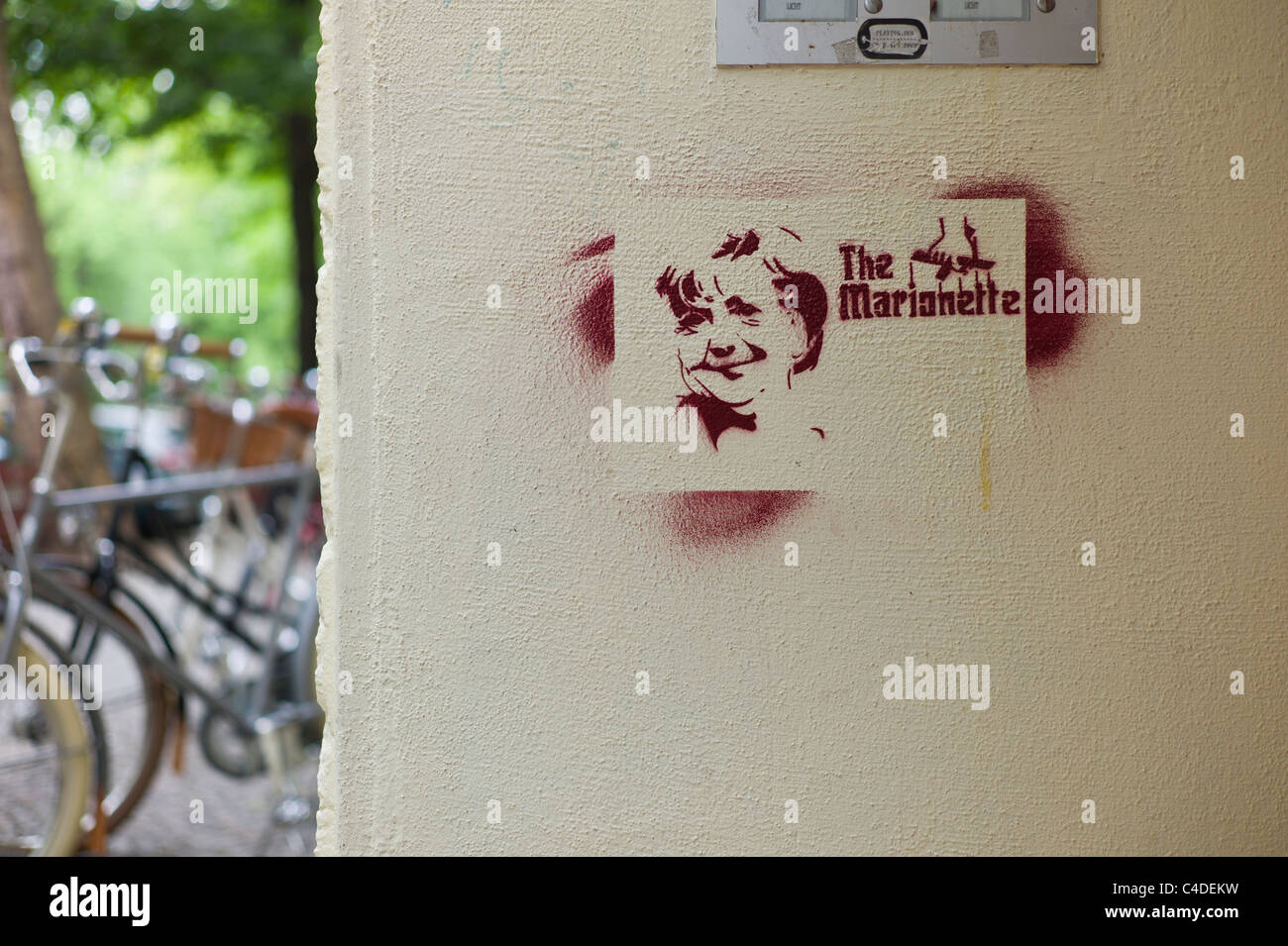Stencil showing the German politician /  Federal Chancellor Angela Merkel's face with the words The Marionette in Berlin Stock Photo