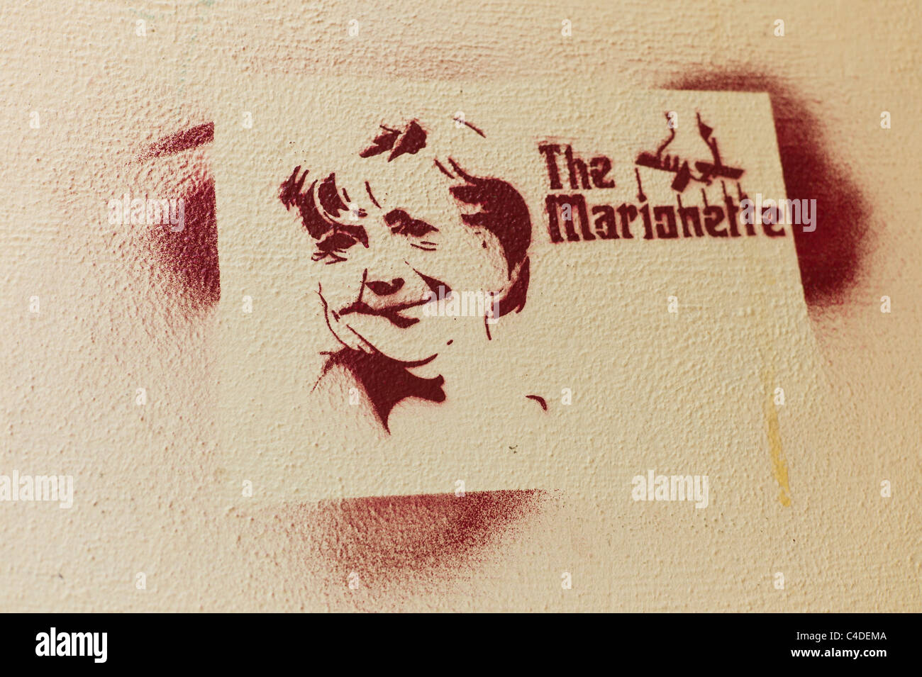 Stencil showing the German politician /  Federal Chancellor Angela Merkel's face with the words The Marionette in Berlin Stock Photo
