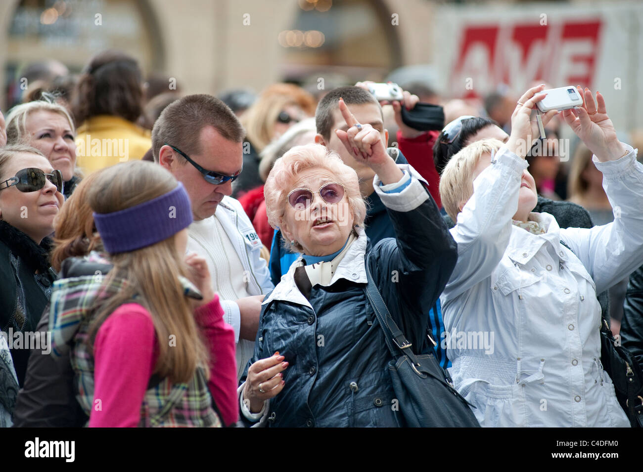 A tour guide points out the Astronomical clock, one of the most visited sights in the Old Town Square, Prague Stock Photo