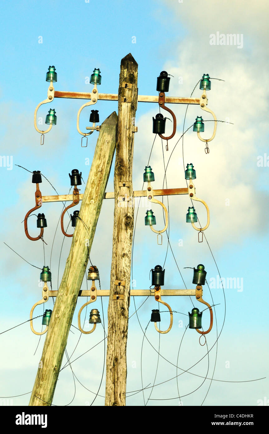 Old telegraph wires cut on wooden pole. Stock Photo