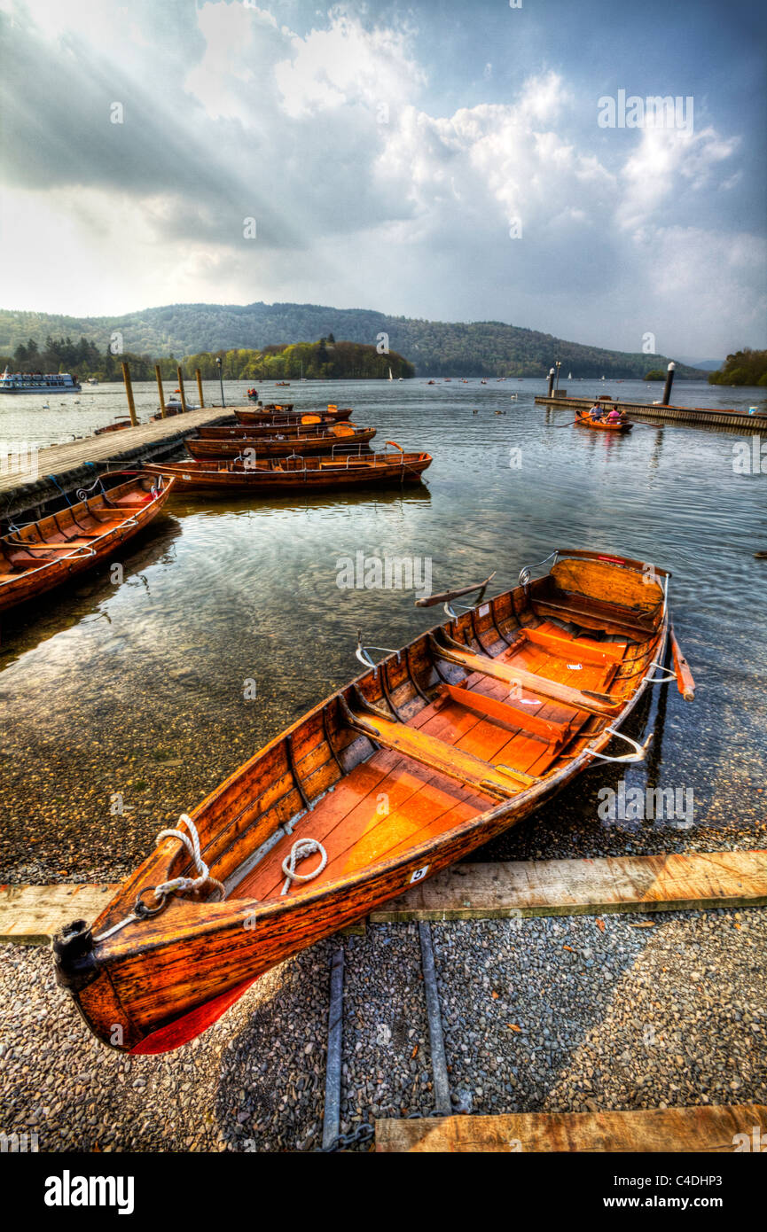 Ambleside on Lake Windermere in Cumbria Cumbrian lakes rowing boats waiting to be used by tourists and rowers hdr image Stock Photo