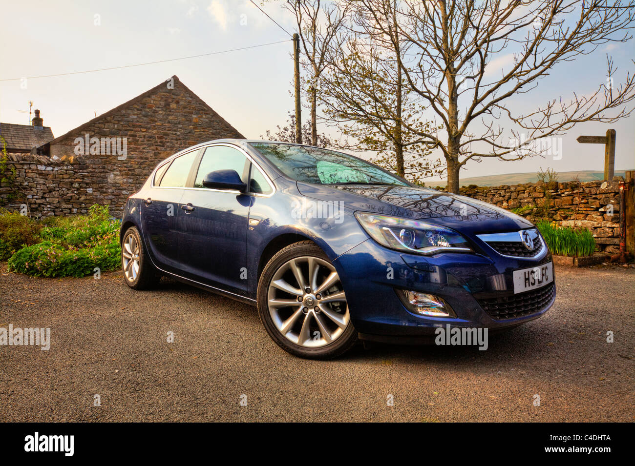 New Vauxhall Astra Diesel parked waiting journey angle to show side and front hdr image yorkshire drystone wall background Stock Photo
