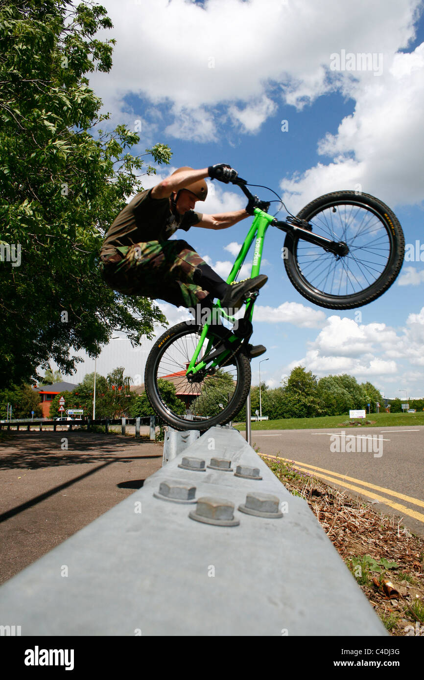 Trials rider balancing on a barrier Stock Photo - Alamy