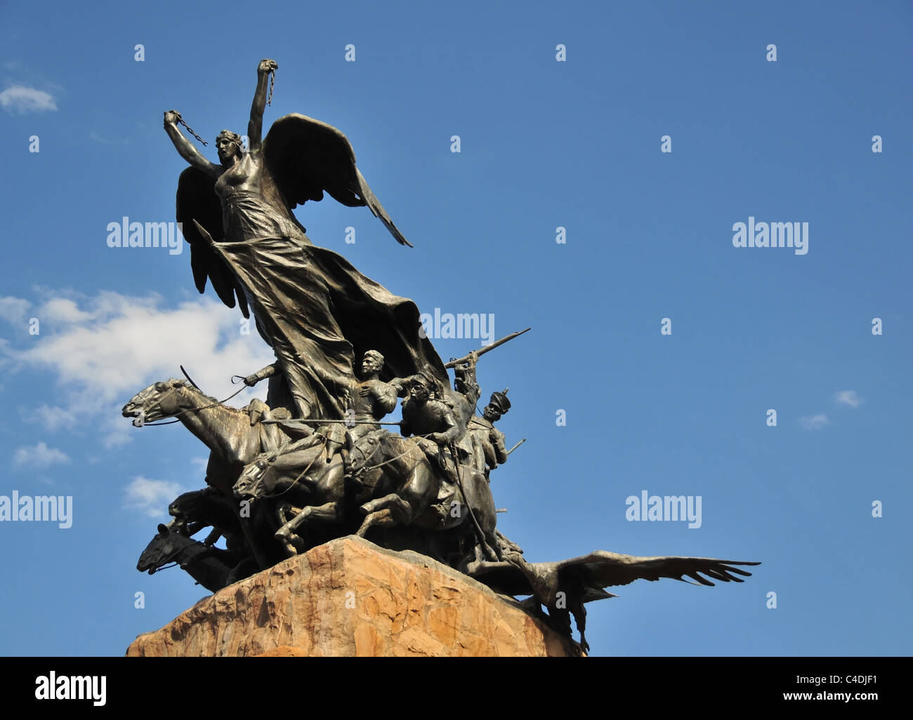 Blue sky Liberty broken chains figure and bronze horse grenadiers, Army of Andes Monument, Cerro Gloria, Mendoza, Argentina Stock Photo