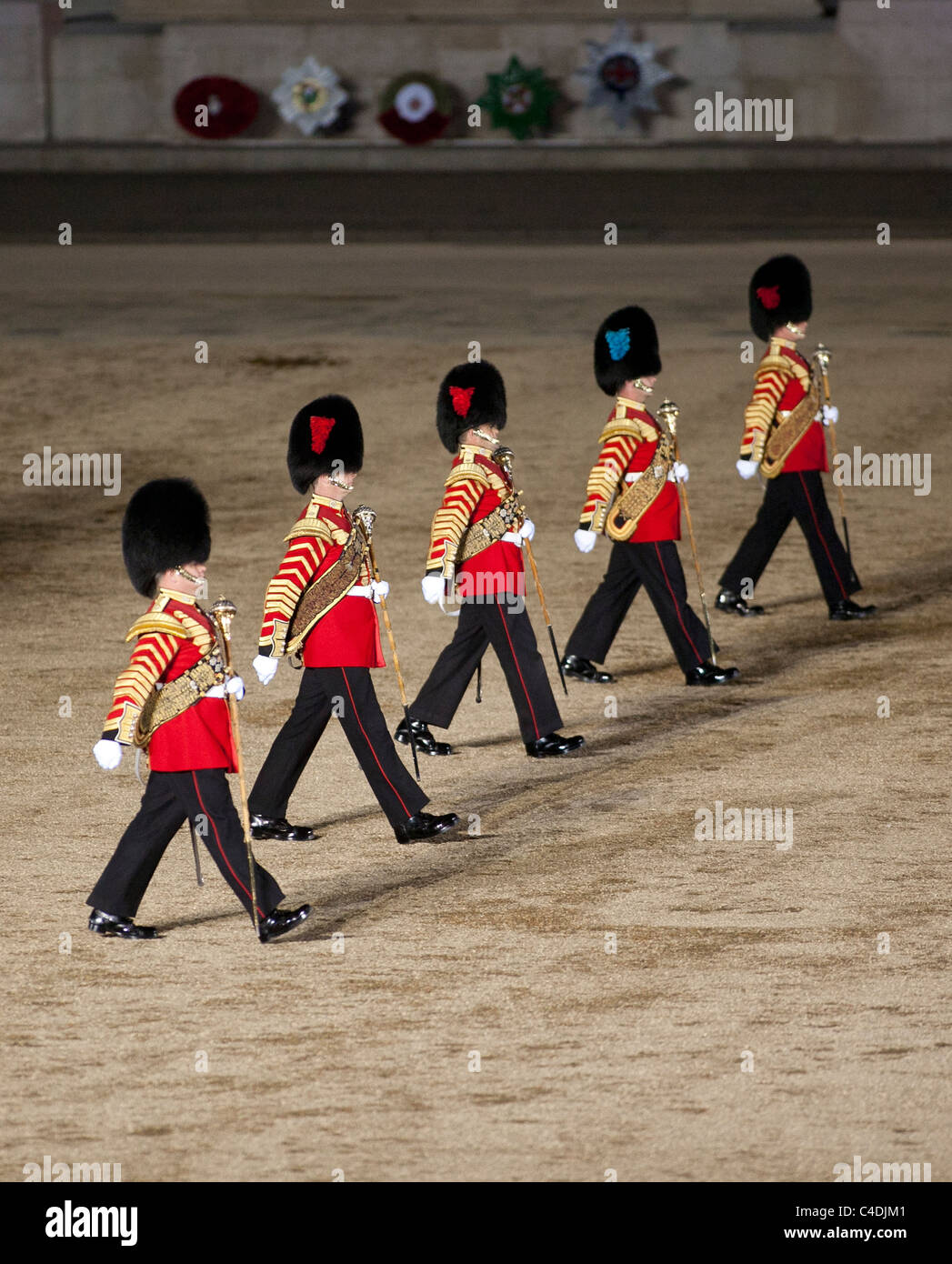 Four drum majors of the British Army Guard regiments march across Horse Guards Parade during the Beating Retreat ceremony. Stock Photo