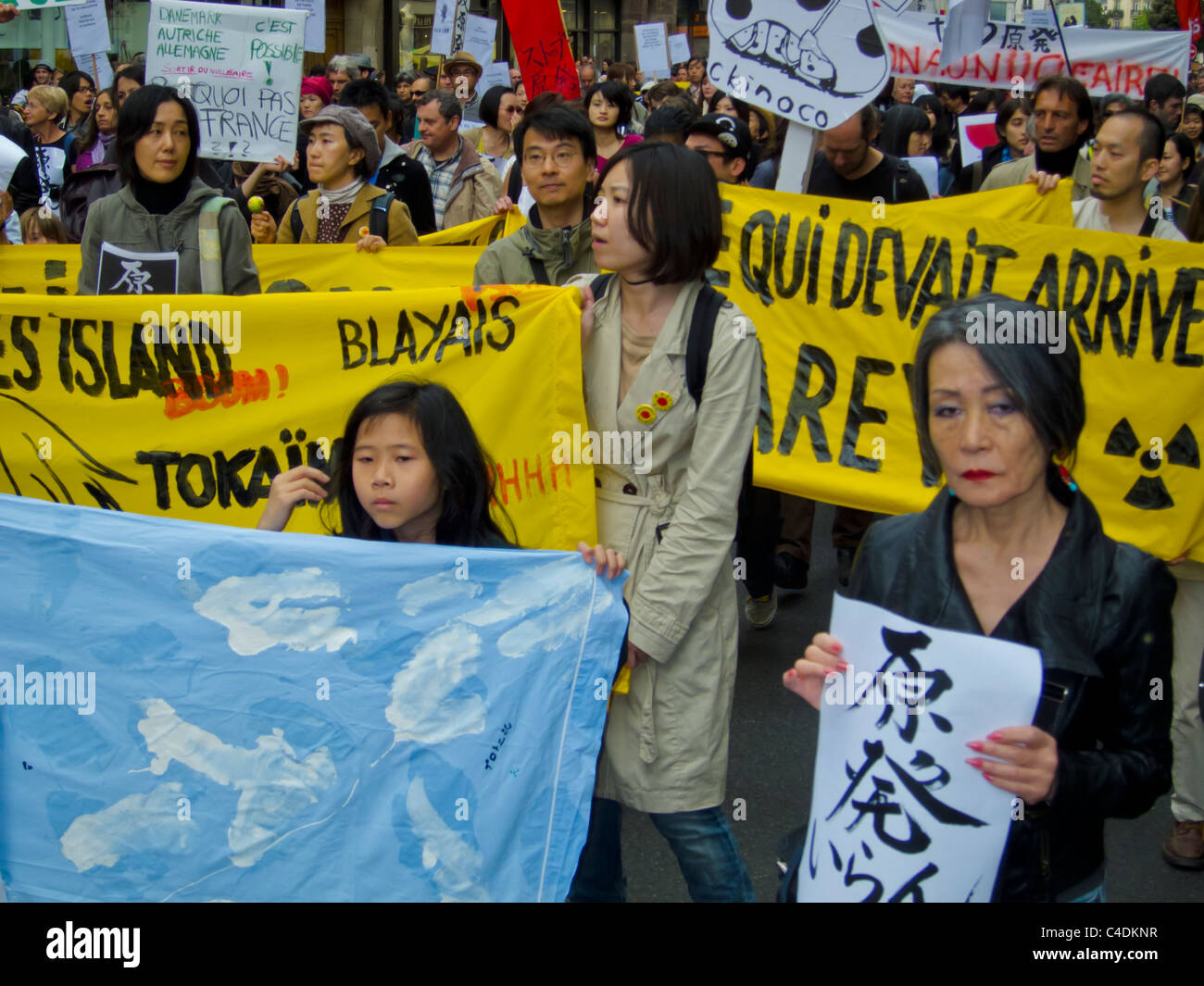 Paris, France, French Demonstration Against Nuclear Power, Japanese People Marching with Signs, Environmental nuclear energy protest Stock Photo