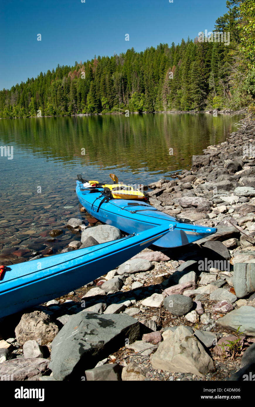 Two kayaks sit on the Kintla Lake shoreline in the western side of Glacier National Park, Montana. Stock Photo