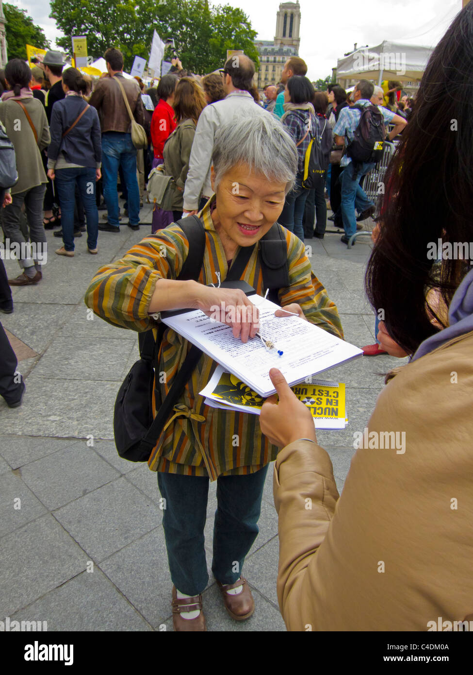 Paris, France, French Demonstration Against Nuclear Power, Japanese Woman Getting Signatures for Petition, volunteer Ngo work Stock Photo