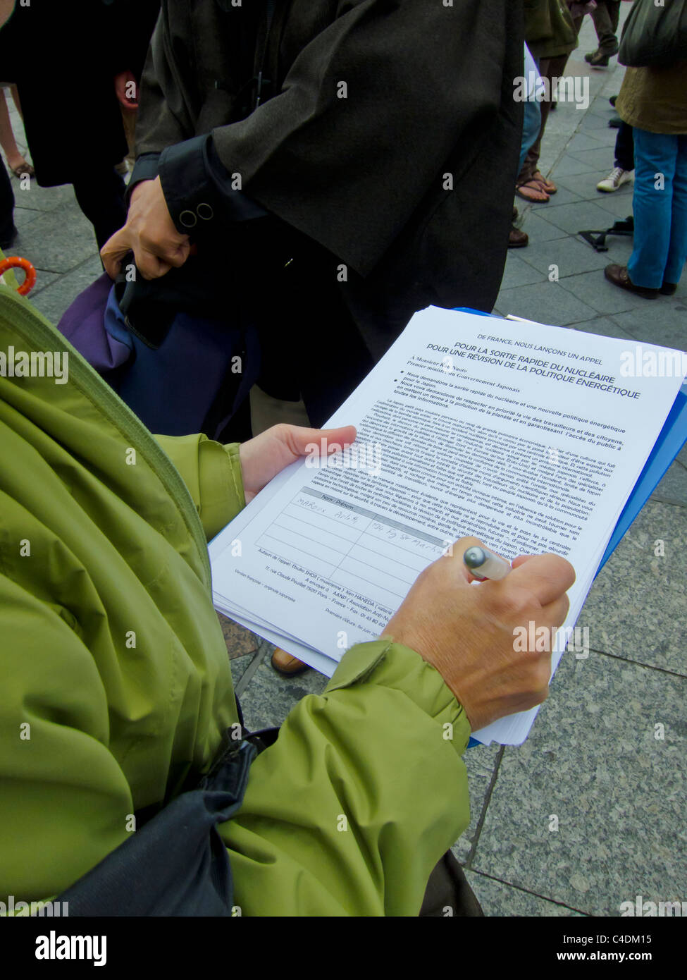 Paris, France, Politics French Demonstration Against Nuclear Power, Woman Signing Petition. volunteer work, nuclear energy protest Stock Photo