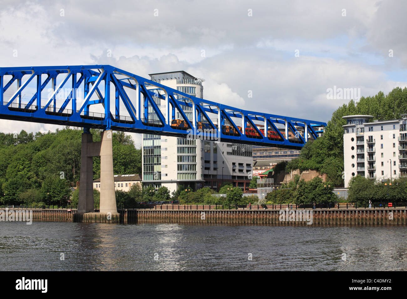 A Tyneside Metro light railway train crosses the river Tyne on a steel girder bridge, Newcastle upon Tyne, England, UK Stock Photo