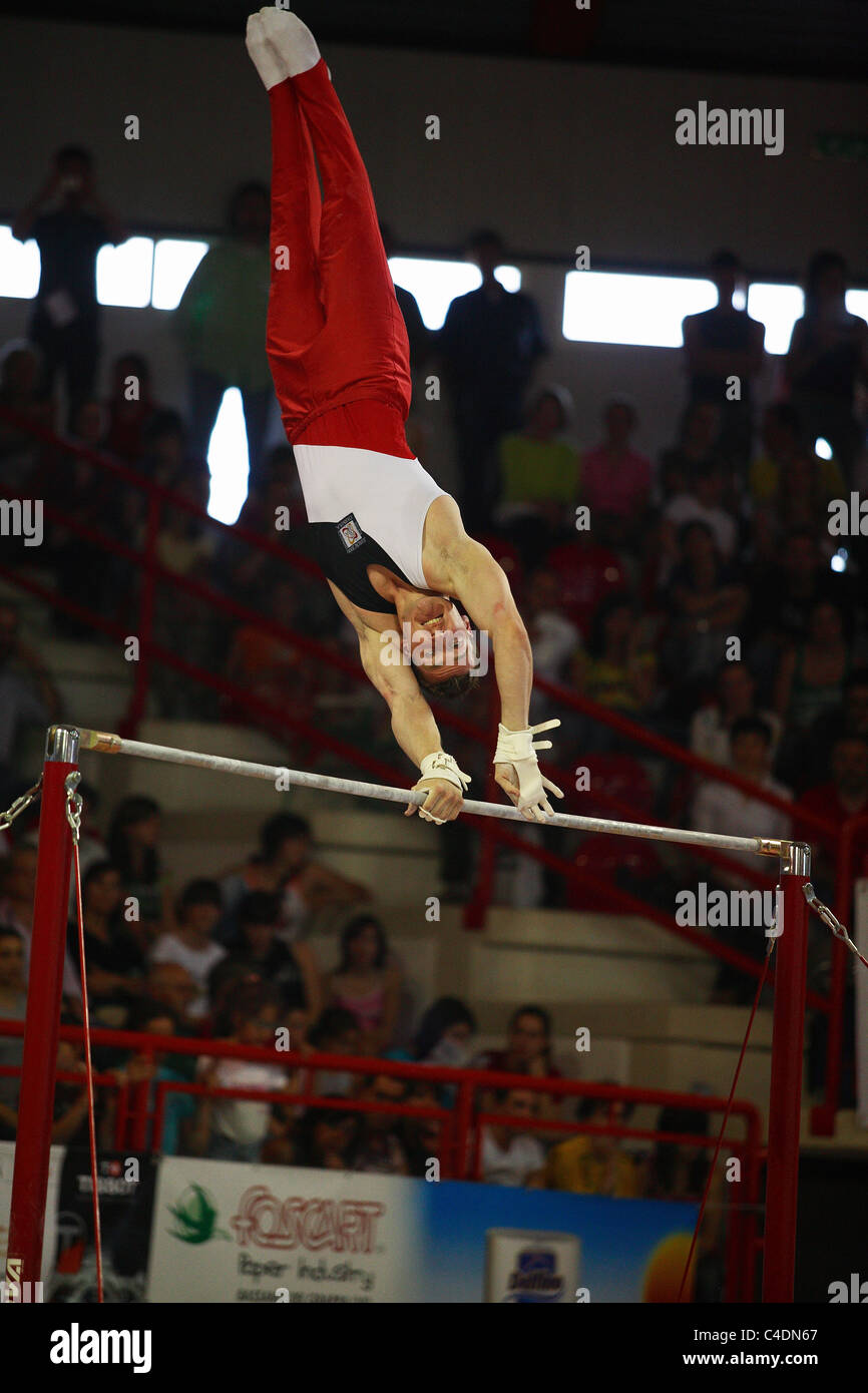 gymnastics competition a gymnast is performing his high bar routine