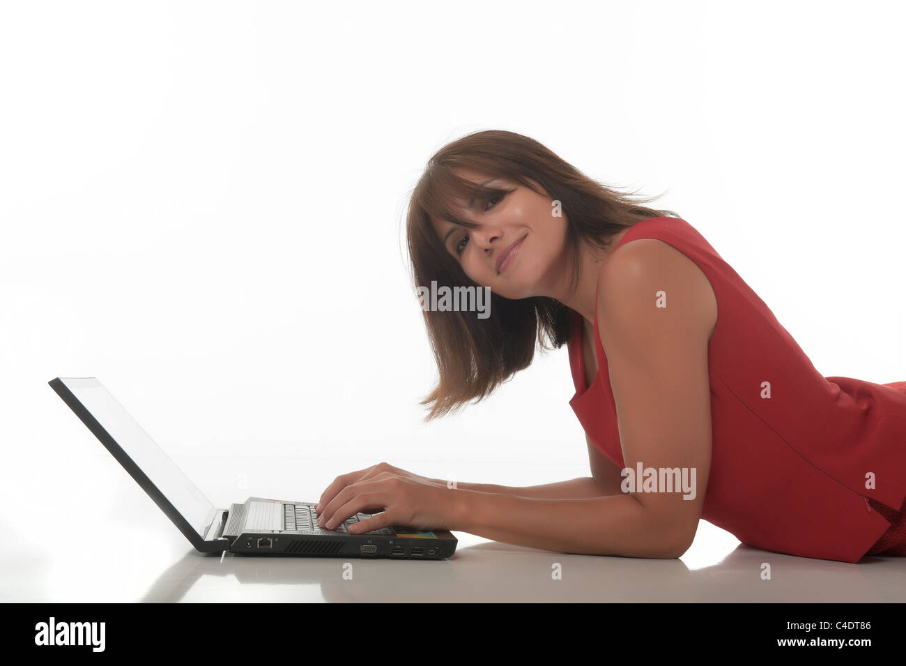 Woman with computer on the floor Stock Photo - Alamy