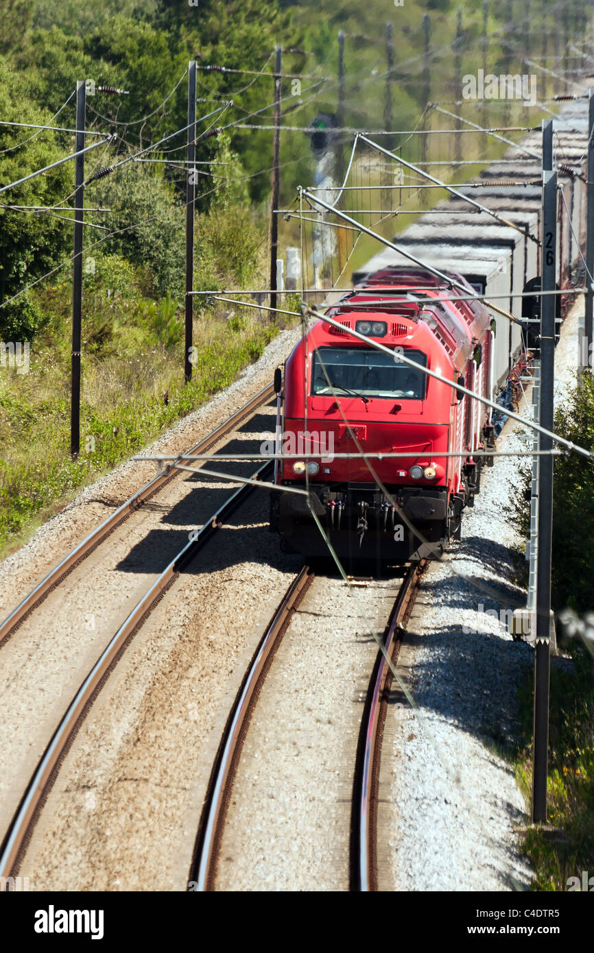 Cargo Train passing with some freight wagons, in Portugal Stock Photo