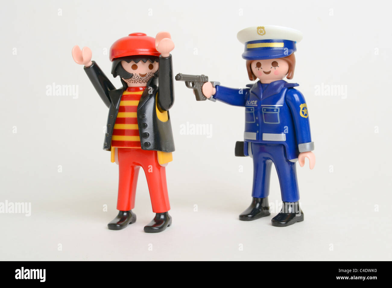 Police Officer criminal arrested arrest crime law gun pistol under arrest Playmobil Stock Photo