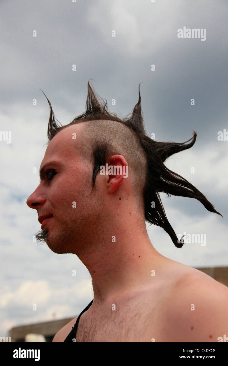 A Gothic enthusiast with Mohawk hairstyle spiked up with gel at the