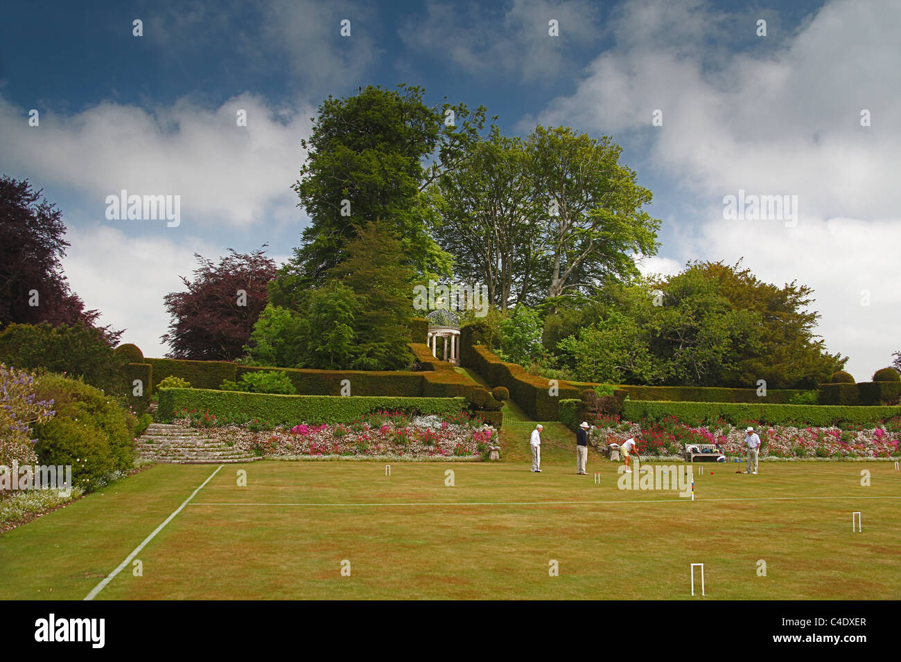 A game of croquet taking place on the croquet lawn at Kingston Maurward