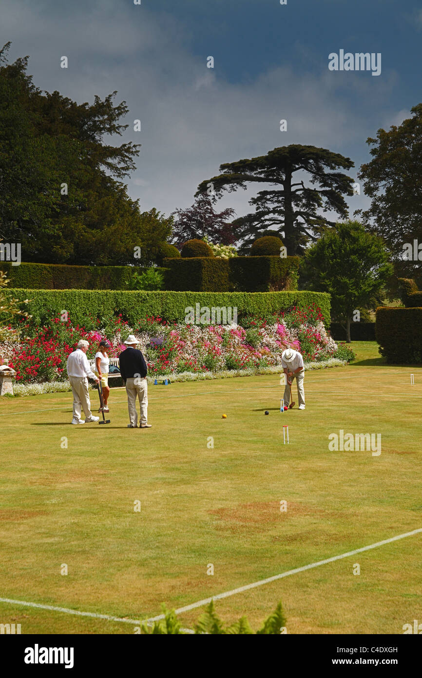 A game of croquet taking place on the croquet lawn at Kingston Maurward