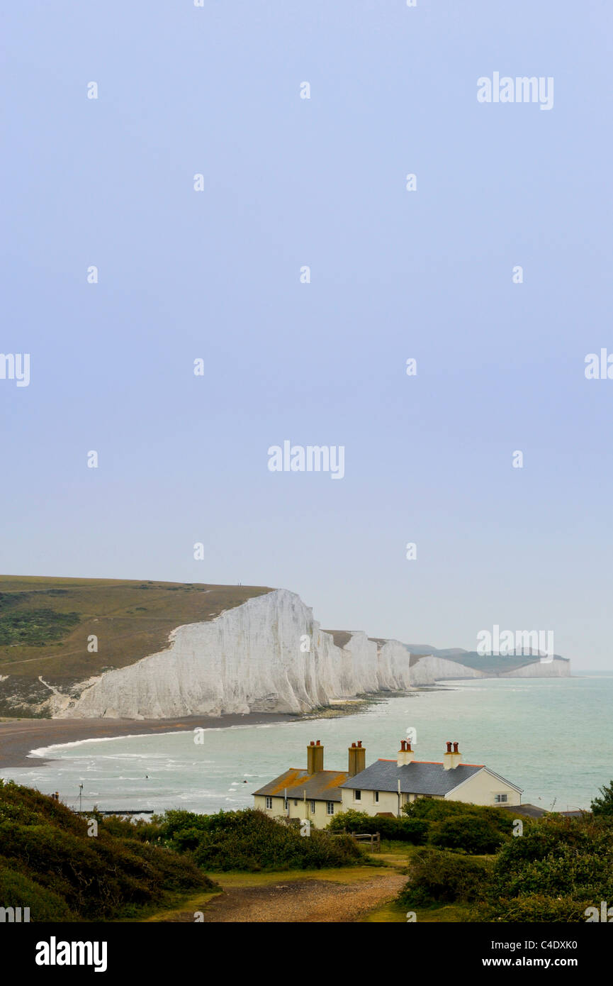 The Seven Sisters cliffs with coastguard cottages in the foreground. Cuckmere Haven, East Sussex, UK. Stock Photo