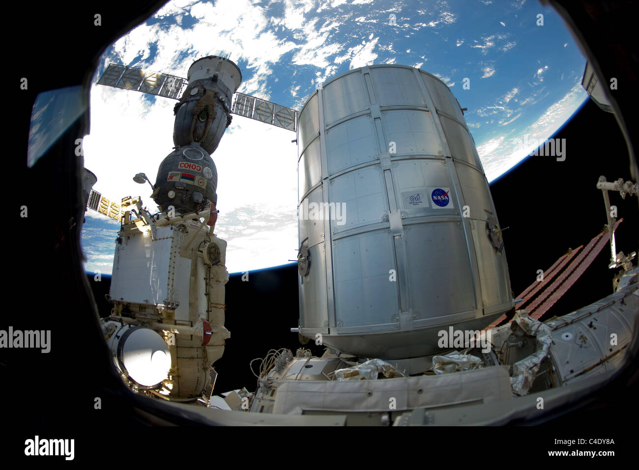 Permanent Multipurpose Module (PMM) and a docked Russian Soyuz spacecraft Stock Photo