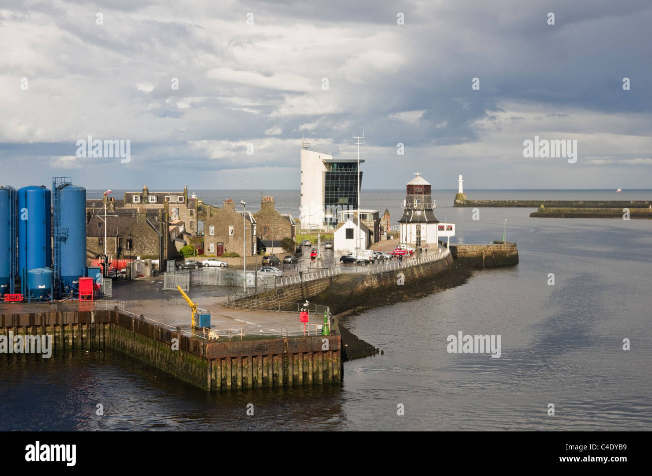 Port entrance with new and old harbour master's buildings on north breakwater with lighthouse beyond. Aberdeen, Scotland, UK. Stock Photo