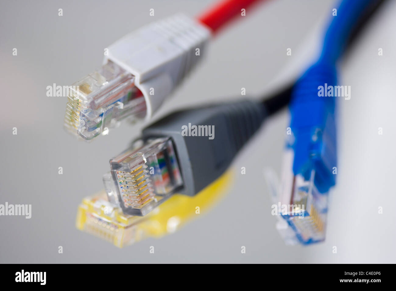 Four RJ-45 Ethernet connectors on white background Stock Photo