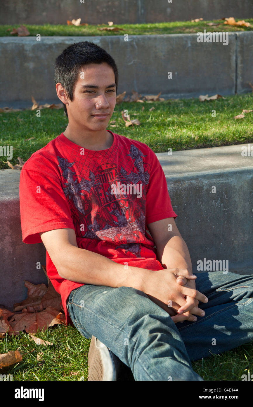 15-18 year old olds Young man Blackfoot American Native American meditating, prayerful thoughtful dreaming sitting thinking alone in park. MR  © Myrleen Pearson Stock Photo